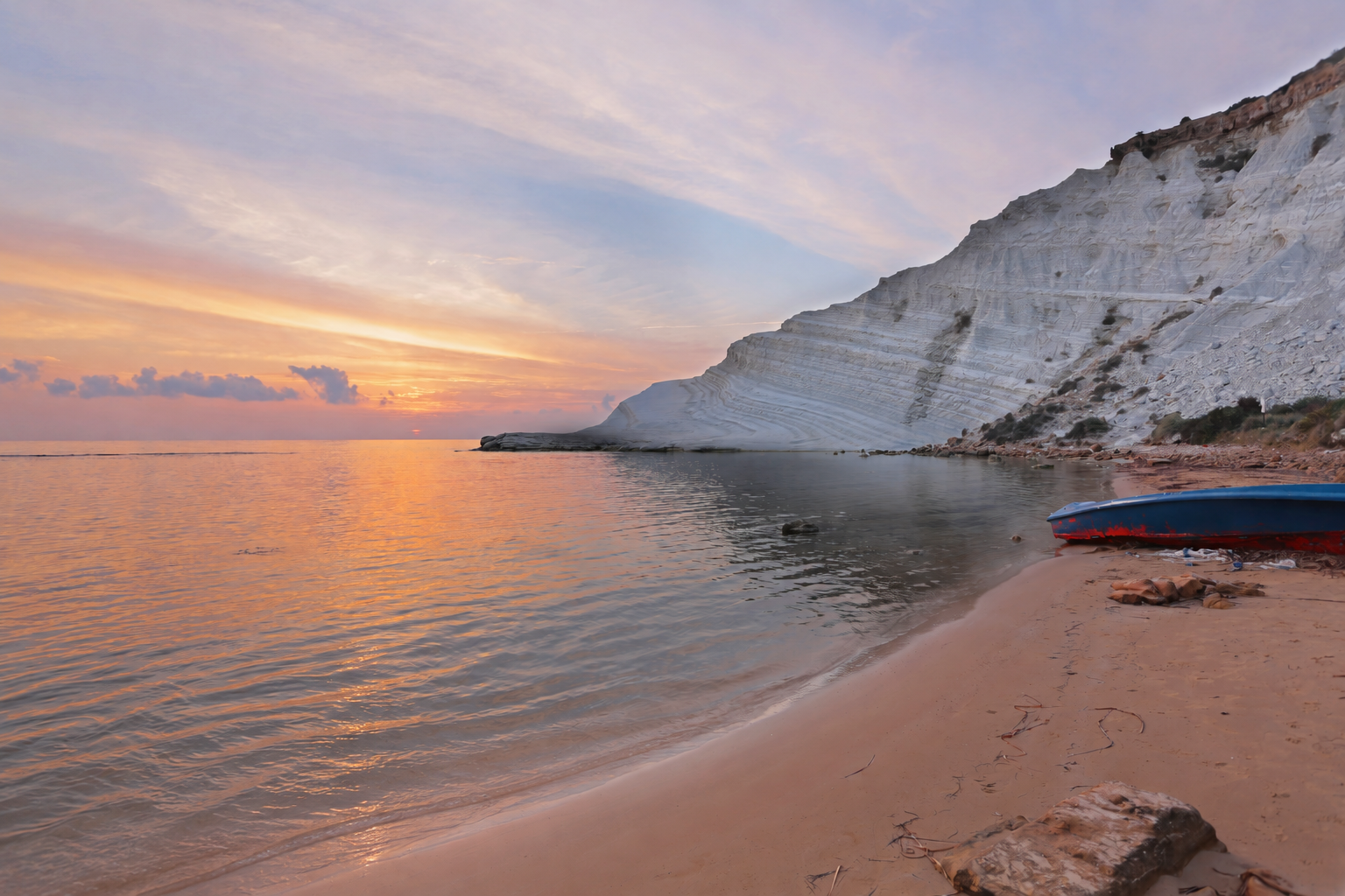 Sunset reflected in the sea beside the white cliffs of Scala dei Turchi, Sicily